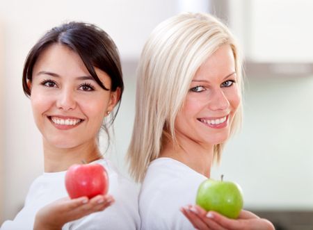 Healthy eating women holding apples and smiling