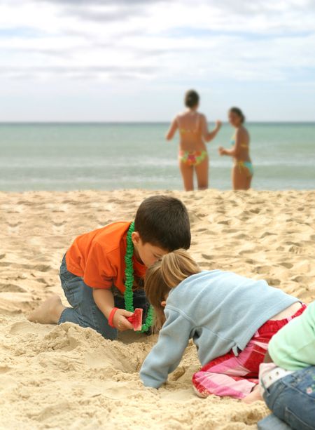 children having fun in the sand