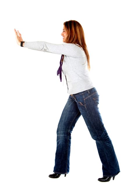 Woman pushing a wall isolated over a white background