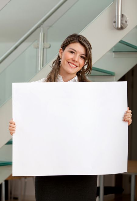 Business woman at the office holding a banner