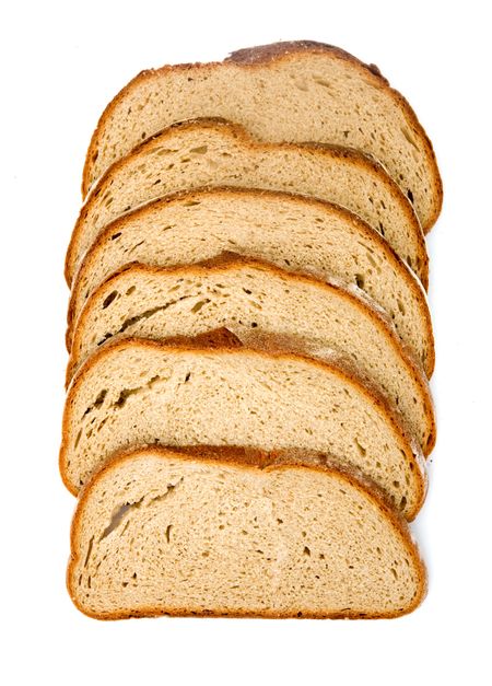 slices of brown wholemeal bread isolated over a white background