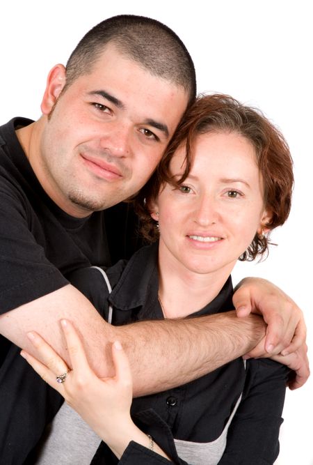 young couple smiling and hugging - isolated over a white background