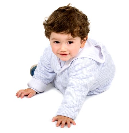 baby boy smiling on the floor portrait - over a white background