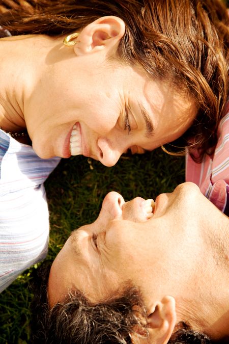 beautiful couple smiling and facing each other on the floor