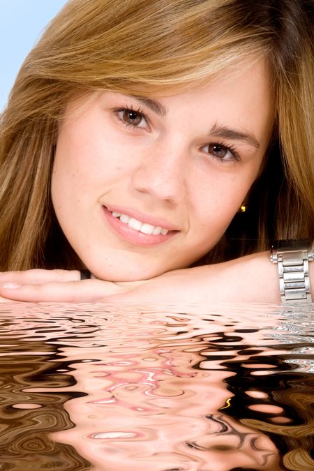 beautiful girl portrait with a water reflection and a light blue background