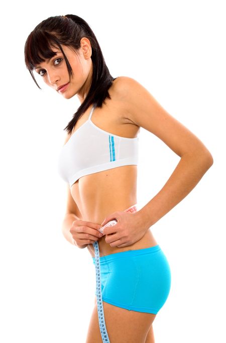 fit girl measuring her waist - fitness series over a white background