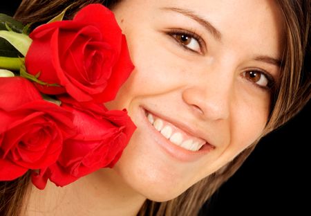 beautiful girl with roses over a black background