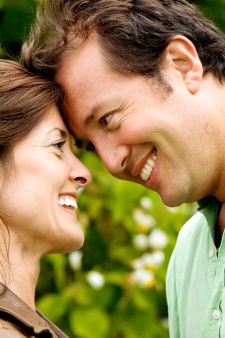 happy couple outdoors looking cute where both are smiling