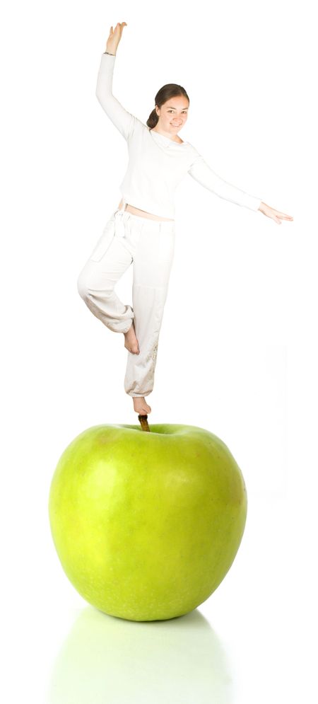 apple in green with reflection and a lady on top balancing