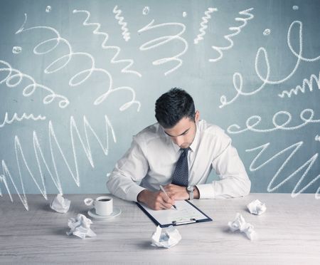 An elegant businessman sitting at office desk and working on keyboard with drawn curves, lines illustration on background wall concept