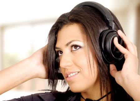 girl listening to music looking happy in her home
