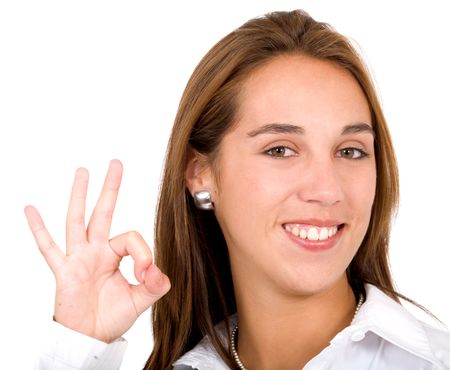 Business woman doing an ok sign smiling over a white background