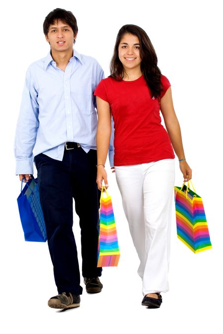 couple shopping with bags full of gifts over a white background