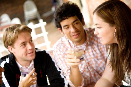 group of friends at a restaurant talking and drinking