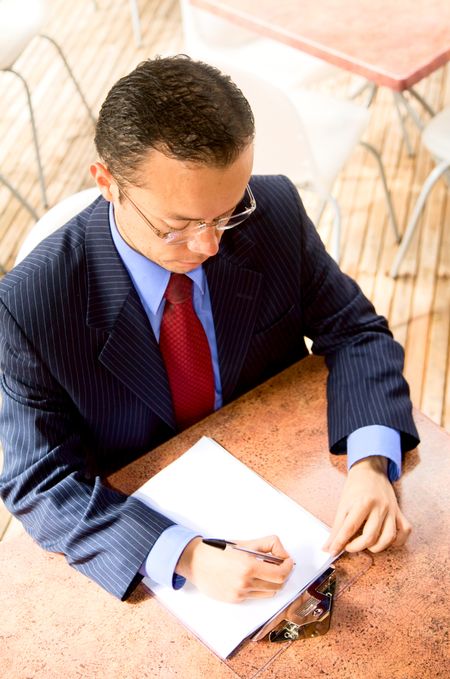 Business man filling a questionaire in a restaurant