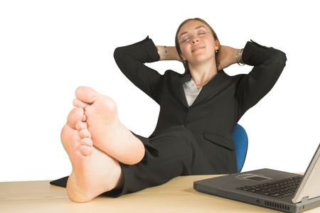 beautiful woman relaxing at her office with her feet up