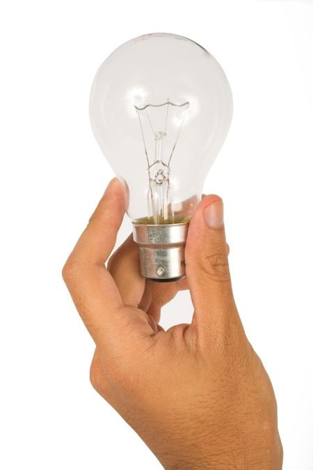 hand holding a clear bulb over a white background