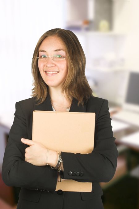 business woman in her office smiling and wearing glasses
