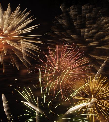 Multicolored fireworks finale in a small section of night sky