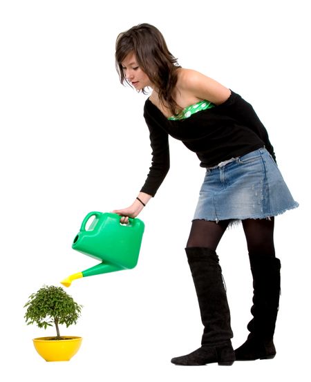 girl watering a tree isolated over a white background