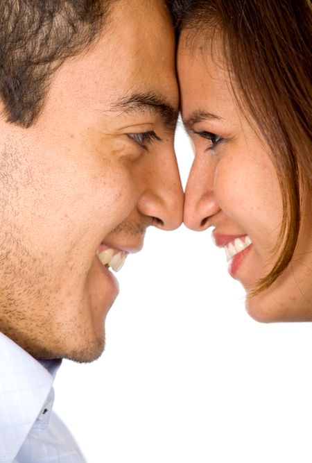 a couple in love face to face smiling - isolated over a white background