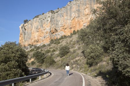 Young Woman on Road in Canyon Landscape; Nuevalos, Aragon, Spain