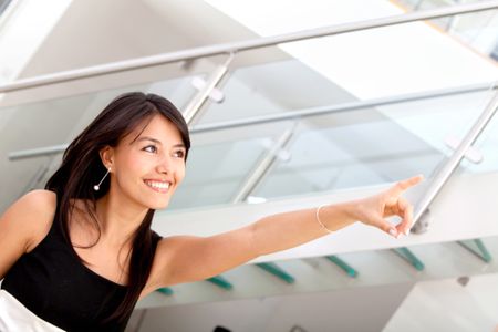 Business woman pointing at something at the office