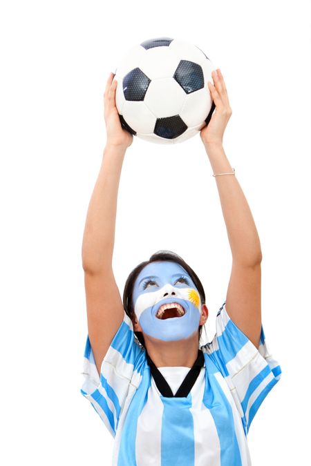 Female argentinean football fan with painted face and holding a ball - isolated