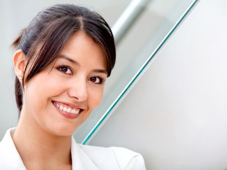 Portrait of a beautiful business woman at the office smiling