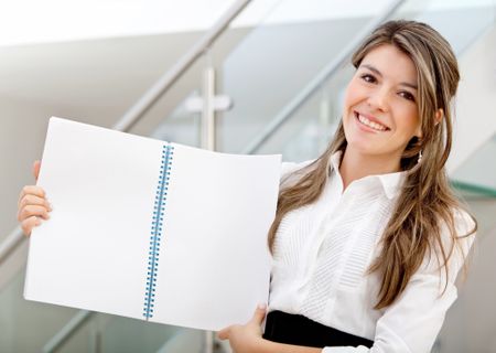 business woman displaying a notebook at the office