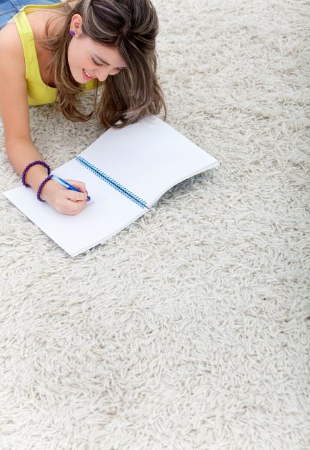 Young woman with a notebook studying at home