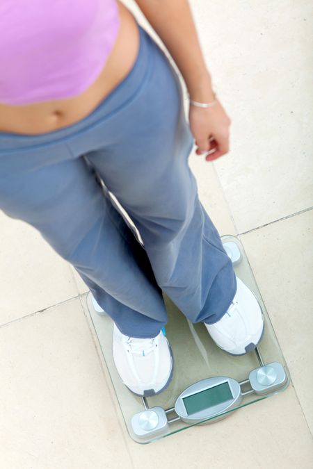 Person standing on a scale - weight loss concepts