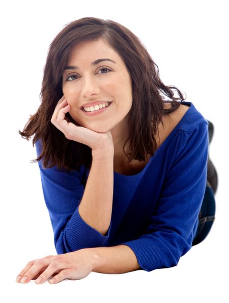 Woman lying on the floor smiling - isolated over a white background