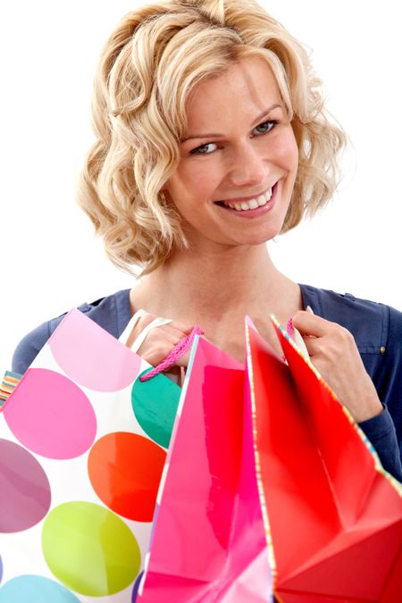 Beautiful shopping woman holding bags isolated over a white background