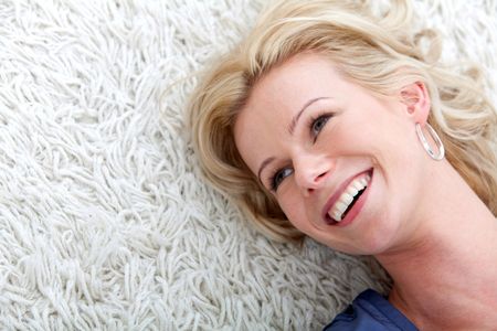 Woman portrait lying on the floor and smiling