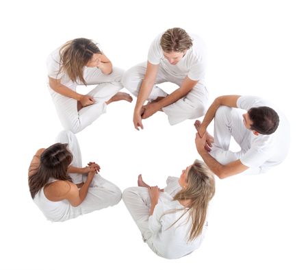 Group of people sitting on a circle wearing white clothes isolated