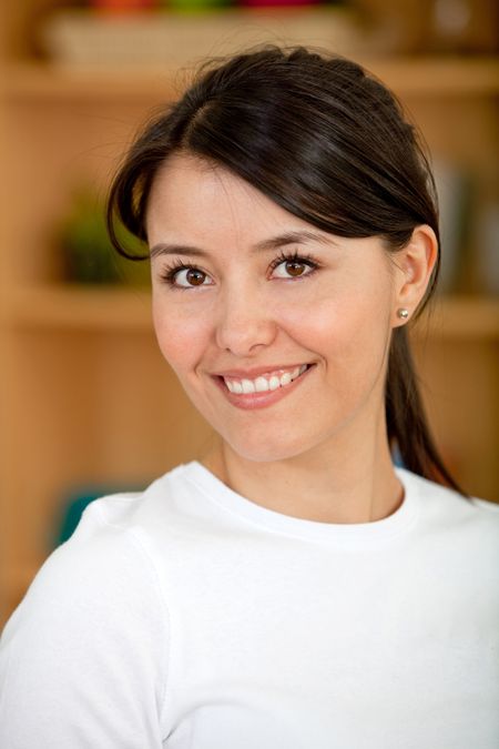 portrait of a beautiful latin woman smiling indoors