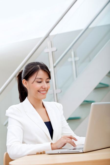 Business woman working on a laptop at the office