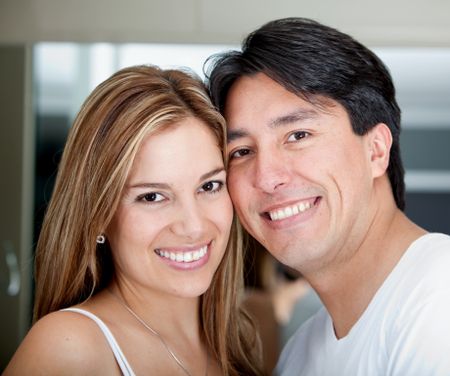 Portrait of a beautiful loving couple smling Handsome man smiling with a woman behind him