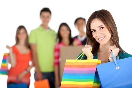 Shopping woman in front of a group - isolated over a white background