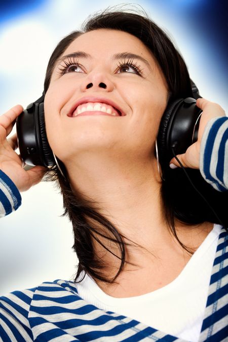 girl listening to music in a nightclub like ambience smiling with a dark backgrounds with strobe lights