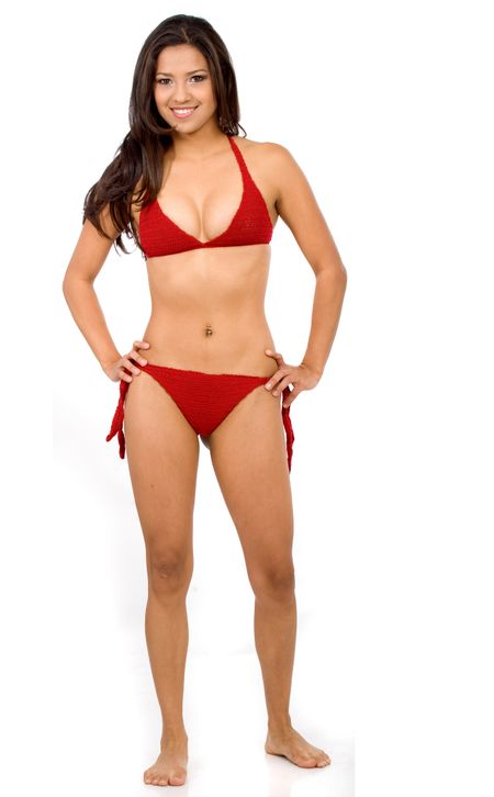 bikini girl standing and smiling over a white background