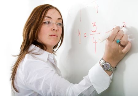 female teacher writing on a blackboard during a maths lesson - over a white background with the focus on her hand