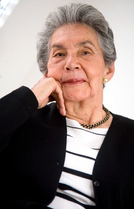 senior woman portrait at home where she looks comfortable and smiling