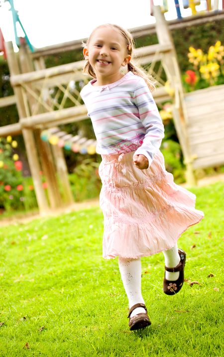 beautiful girl having fun at a park - running toward the camera