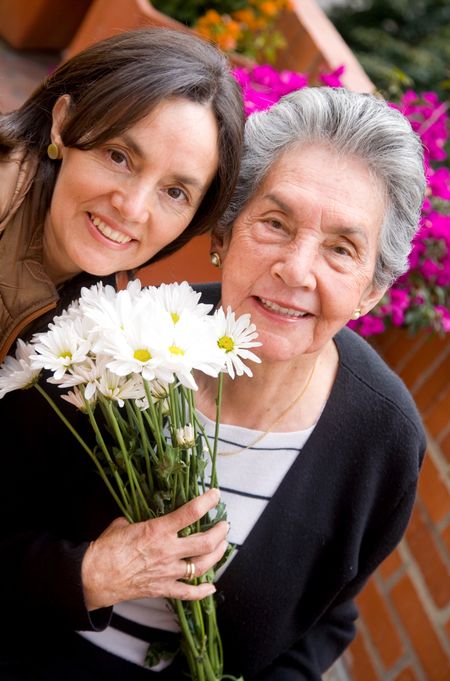 mother and daughter portrait outdoors with flowers