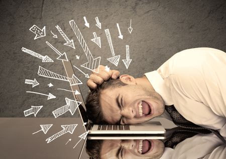 An exhausted business person resting his head on keyboard with pressure illustrated by arrows pointing at him concept