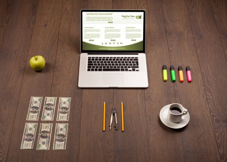 Business wooden table with notebook computer and office accessories