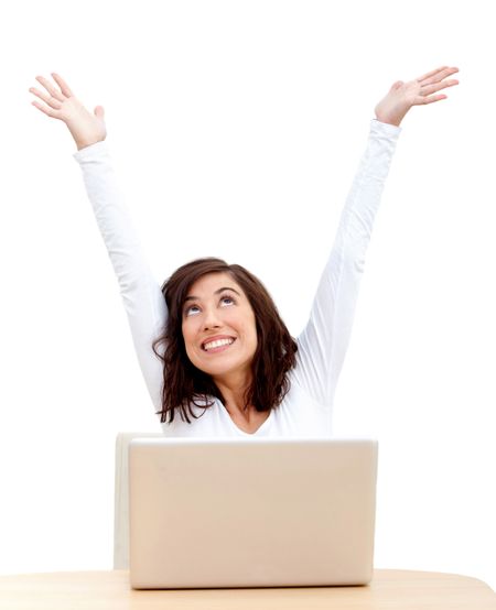 Excited woman with laptop and arms up