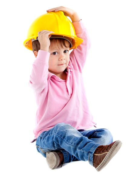 Beautiful kid on the floor playing with a helmet  - isolated over a white background